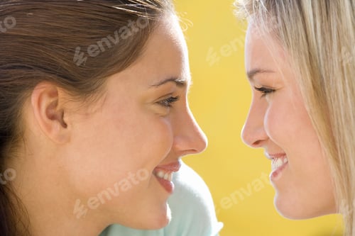 Preview: Two Young Women Smiling At Each Other, Close-Up, Side View
