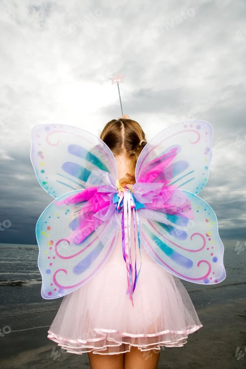 Preview: Rear View Young Girl Wearing Fairy Costume Looking Out Over Ocean