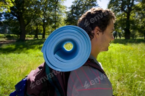 Preview: Man On Vacation Walking In Countryside With Camping Gear On Back