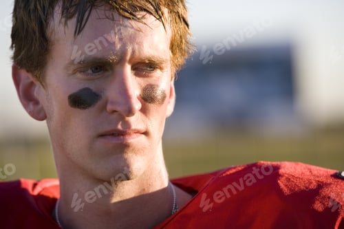 Preview: American Football Player Wearing Red Football Strip And Black Face Paint, Close-Up, Front View
