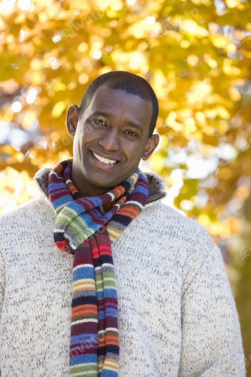 Preview: Smiling Man In Scarf And Sweater Standing Outdoors In Autumn