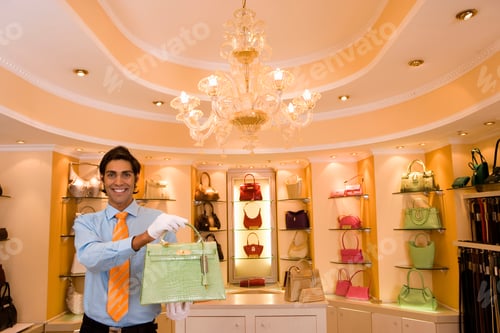 Preview: Portrait Of Sales Assistant Wearing Gloves In Handbag Store