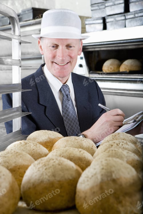 Preview: Inspector Examining Loaves Of Bread In Bakery