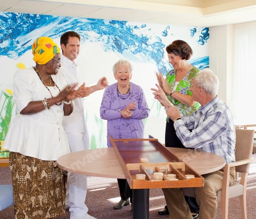 Preview: Group Of Senior Residents In Care Home Playing Shuffleboard Together