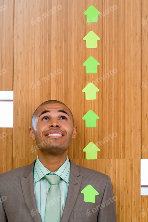 Preview: Businessman In Office Looking At Line Of Ascending Sticky Arrows