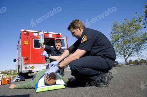Preview: Paramedic And Colleague Helping Man On Stretcher, Low Angle View