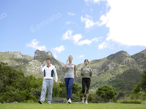Preview: Low Angle View Of Two Young Women And A Young Man Jogging