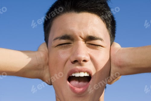 Preview: A Teenage Boy Covering His Ears.