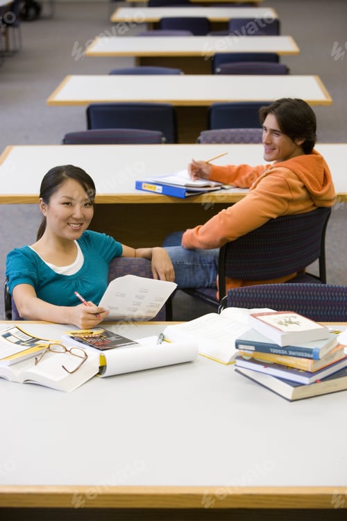 Preview: Young Man And Woman Studying In Library, Man Smiling At Woman, Elevated View