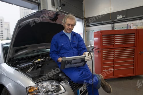 Preview: Mechanic With Diagnostic Computer On Car With Open Bonnet