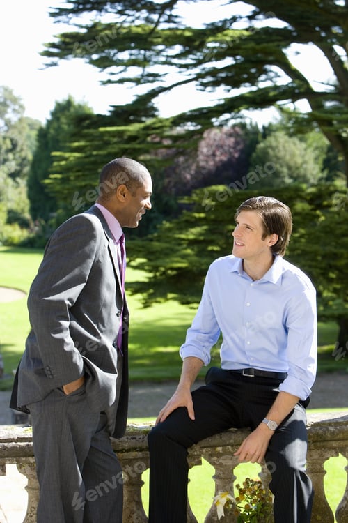 Preview: Businessman In Conversation With Colleague Outdoors
