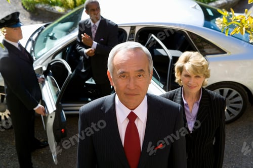 Preview: Businessman And Colleagues Getting Out Of Chauffeur Driven Car