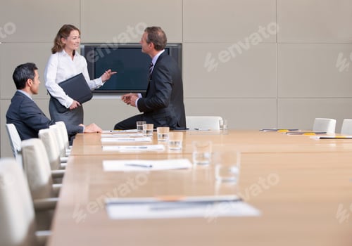 Preview: Businessmen And Businesswoman Having Discussion In Conference Room