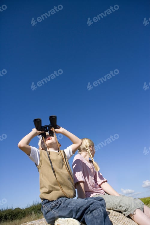 Preview: Boy Using Binoculars By Sister (8-10), Low Angle View