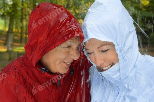 Preview: A Senior Couple Wearing Raincoats In The Rain.