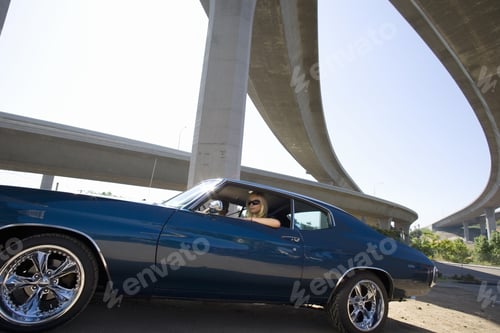 Preview: Young Couple In Car Beneath Overpass, Low Angle View (Lens Flare)