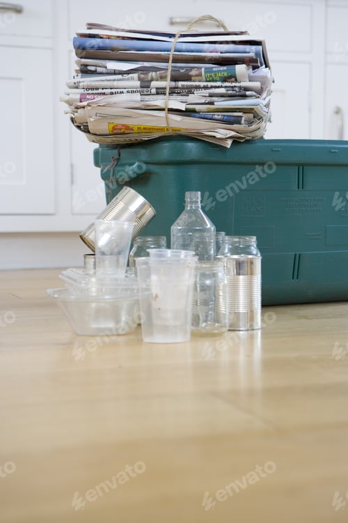Preview: Newspaper Bundle On Recycling Bin By Empty Glass Jars And Tin Cans