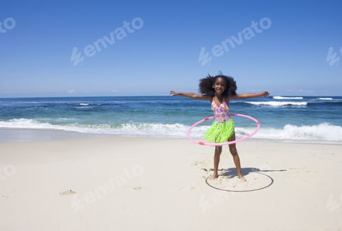Preview: Girl (6-8) Playing With Plastic Hoop Near Water'S Edge On Sandy Beach, Arms Out, Front View