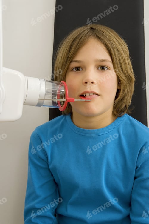 Preview: Boy Receiving Dental X-Ray in Dentist Office