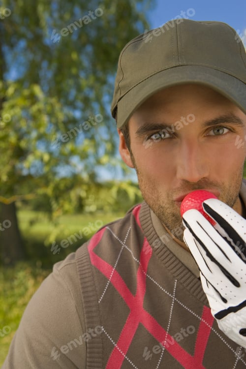 Preview: Portrait Of A Mid Adult Man Kissing A Golf Ball