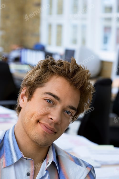 Preview: Portrait Of Young Businessman In Start Up New Business Working At Desk In Modern Office