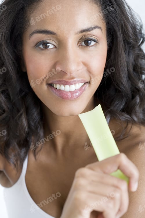Preview: A Woman Holding A Stick Of Celery