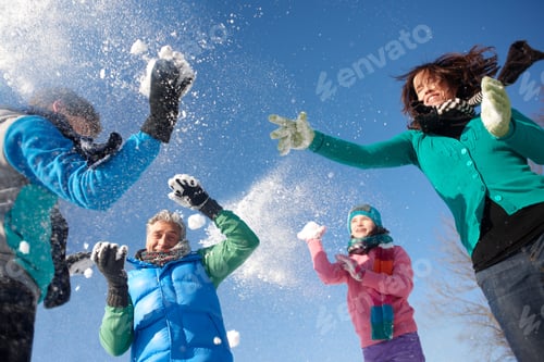Preview: Laughing Family On Winter Vacation Having Snowball Fight On Mountain