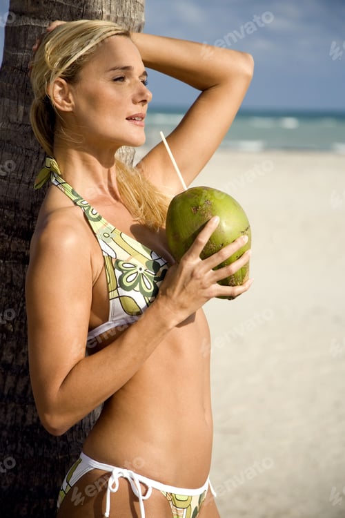 Preview: A Young Woman In A Bikini Standing On A Beach
