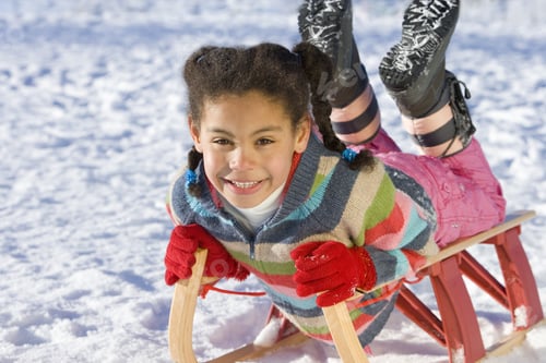 Preview: Excited Girl Sledding Down Snowy Hill On Sled