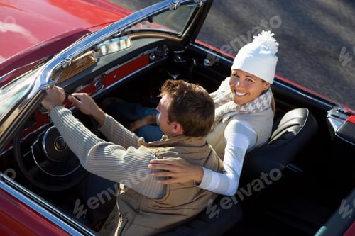 Preview: Loving Mature Couple Driving Classic Red Convertible Car On Road Trip