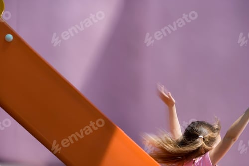 Preview: Action Shot On Girl Playing On Playground Slide