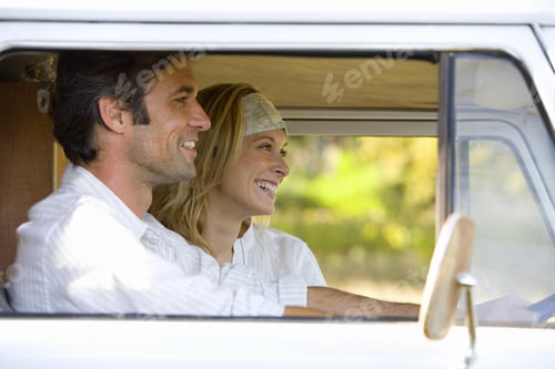 Preview: Young Couple In Camper Van, Man Driving, Smiling, Side View