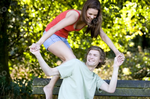 Preview: A Young Couple Having Fun On A Park Bench
