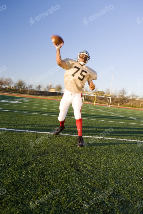 Preview: American Football Quarterback Throwing Ball During Competitive Game, Front View (Tilt)