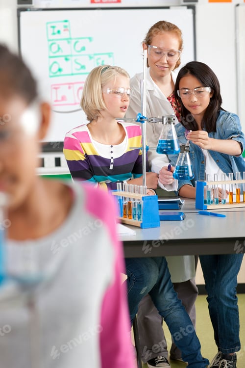 Preview: Teacher Helping Students With Experiment In School Chemistry Laboratory