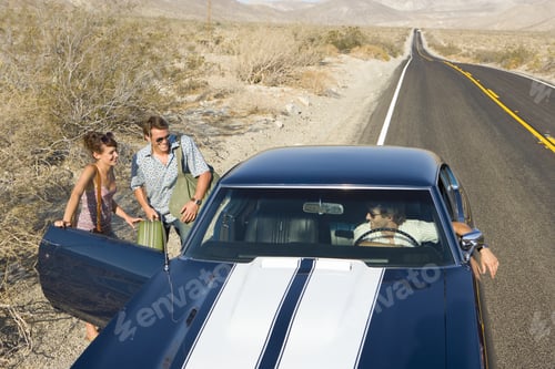 Preview: Young Couple Hitchhiking On Desert Road, In Conversation With Driver Of Car, Elevated View