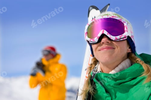Preview: Smiling Couple In Goggles Carrying Skis On Winter Vacation In Mountains