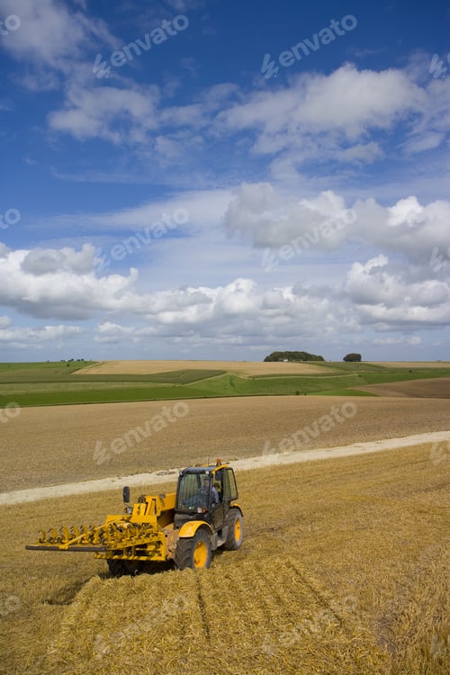 Preview: Tractor Collecting Straw Bales In Sunny Rural Field