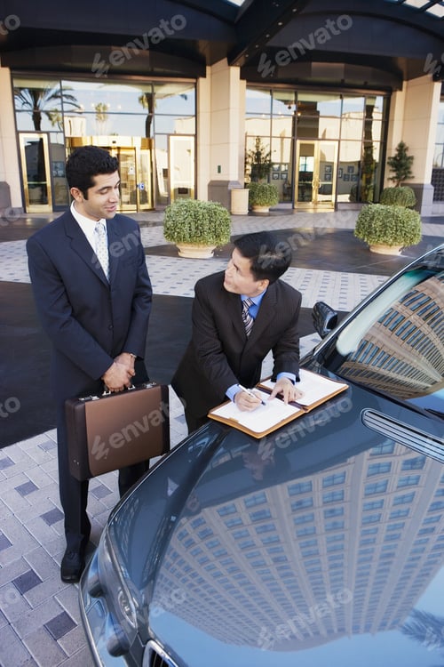 Preview: Two Businessmen Standing Beside Car Outside Hotel, Man Signing Contract, Smiling