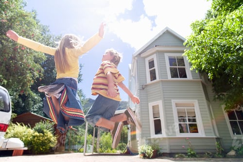 Preview: Excited Children Jumping In Air Playing On Driveway Outside House