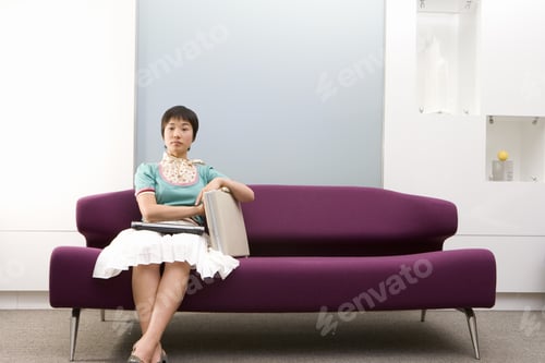Preview: Young Woman With Briefcase On Sofa, Portrait