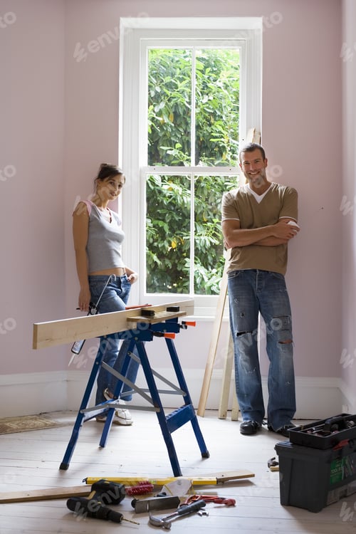 Preview: Couple Doing Diy At Home, Woman Holding Glue Gun Beside Timber On Workbench, Smiling, Portrait