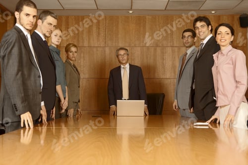 Preview: Group Of Business Executives Standing In A Board Room
