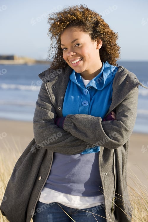 Preview: Happy Woman With Arms Crossed On Beach
