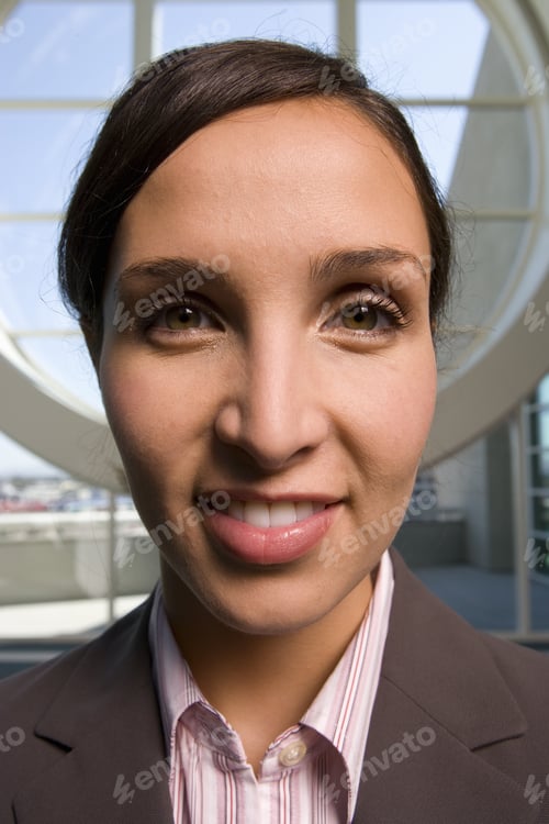 Preview: Businesswoman Standing In Front Of Round Window
