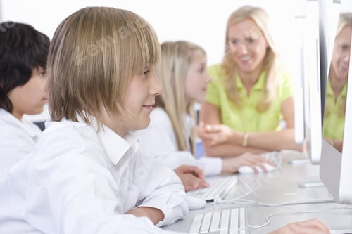 Preview: Teacher Helping Students Working On Computers In School Computer Lab