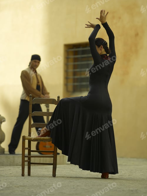 Preview: Side Profile Of A Female Dancer Dancing With A Young Man Holding A Guitar In The Background