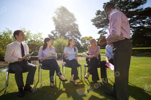 Preview: Businessmen And Women On Training Course Outdoors By Manor House