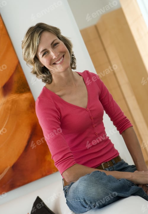 Preview: Woman Wearing Red Top And Jeans, Relaxing At Home, Smiling, Portrait (Tilt)