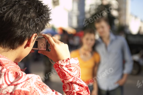 Preview: A Boy Taking A Photo With His Digital Camera.